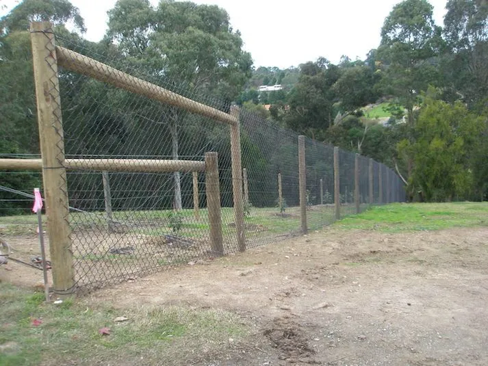 Rural fence with strainer assembly